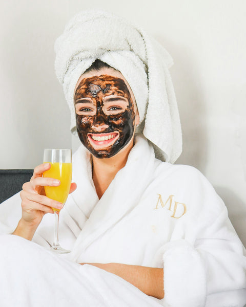 Person applying Dead Sea Miracle Mud for skincare.